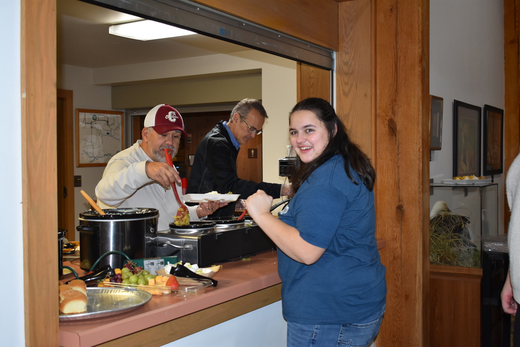 A student receiving her meal from staff