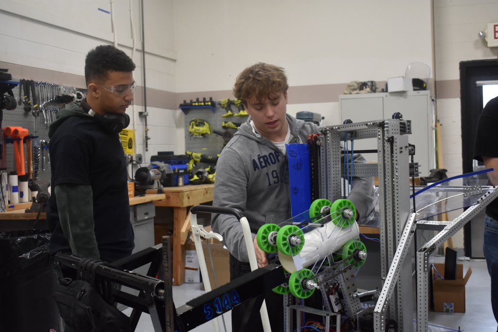Two students demonstrate in robotics