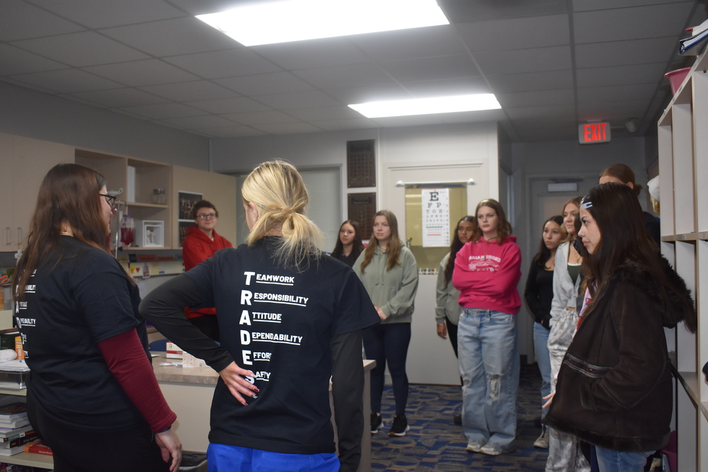 Two students present about the CNA program to guests