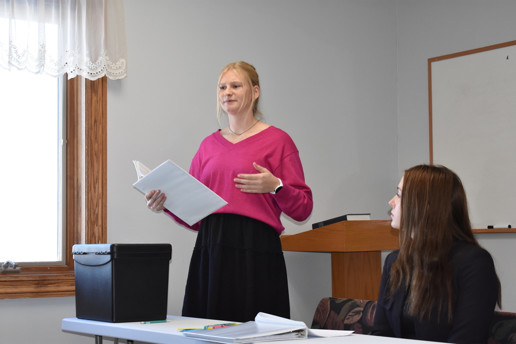 Student presenting her argument while her partner listens in 