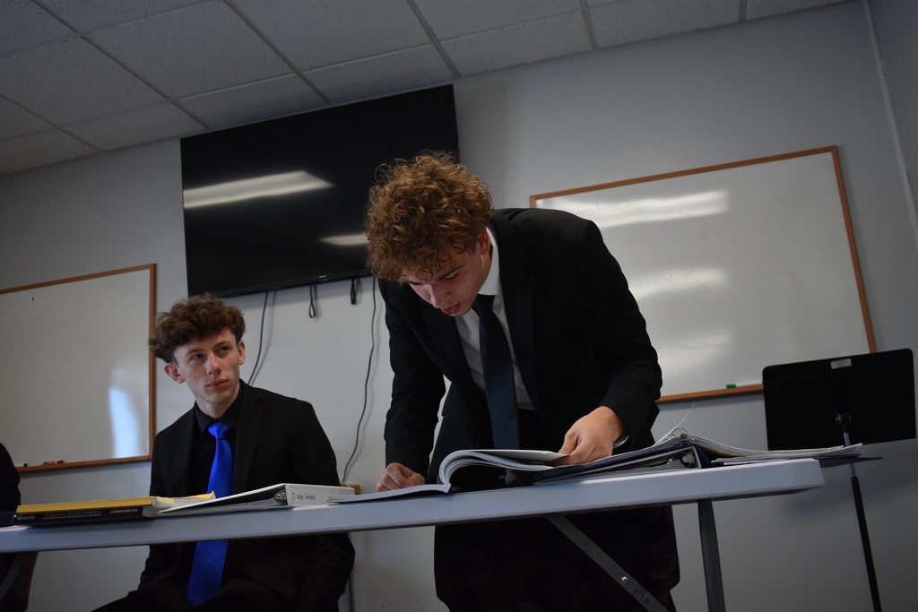 Student looking for argument while partner listens in 