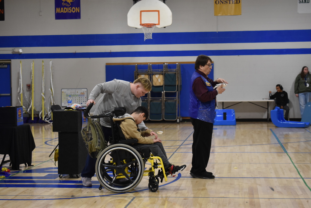 Two students walking away from a magic trick with a live bird. 