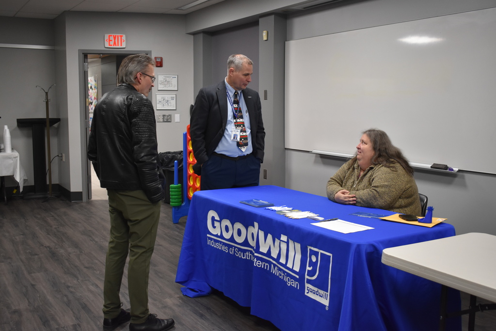 Superintendent Mark Haag and  a board member chatting with a Goodwill representative at the Transitions Fair