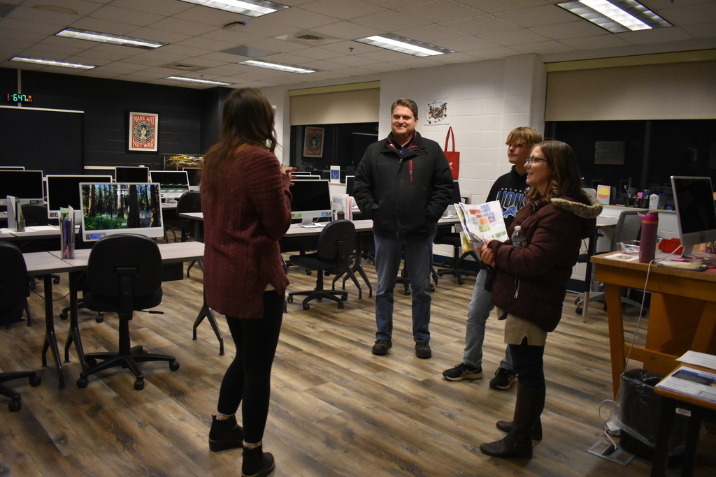 A family learning about Graphic Design from the instructor