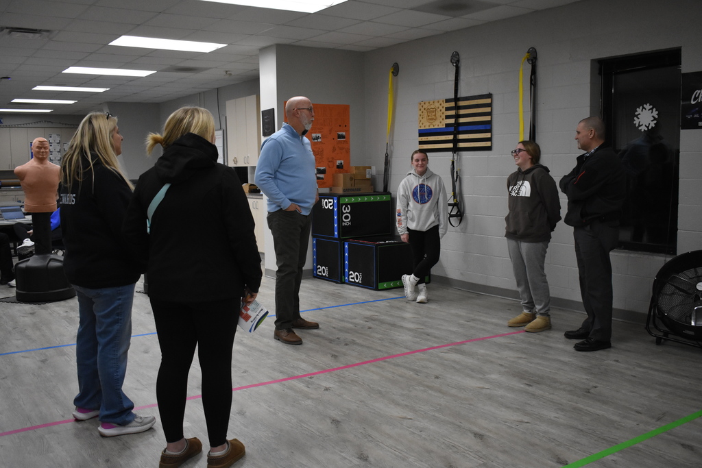 The Law Enforcement and Corrections instructor speaking with a family