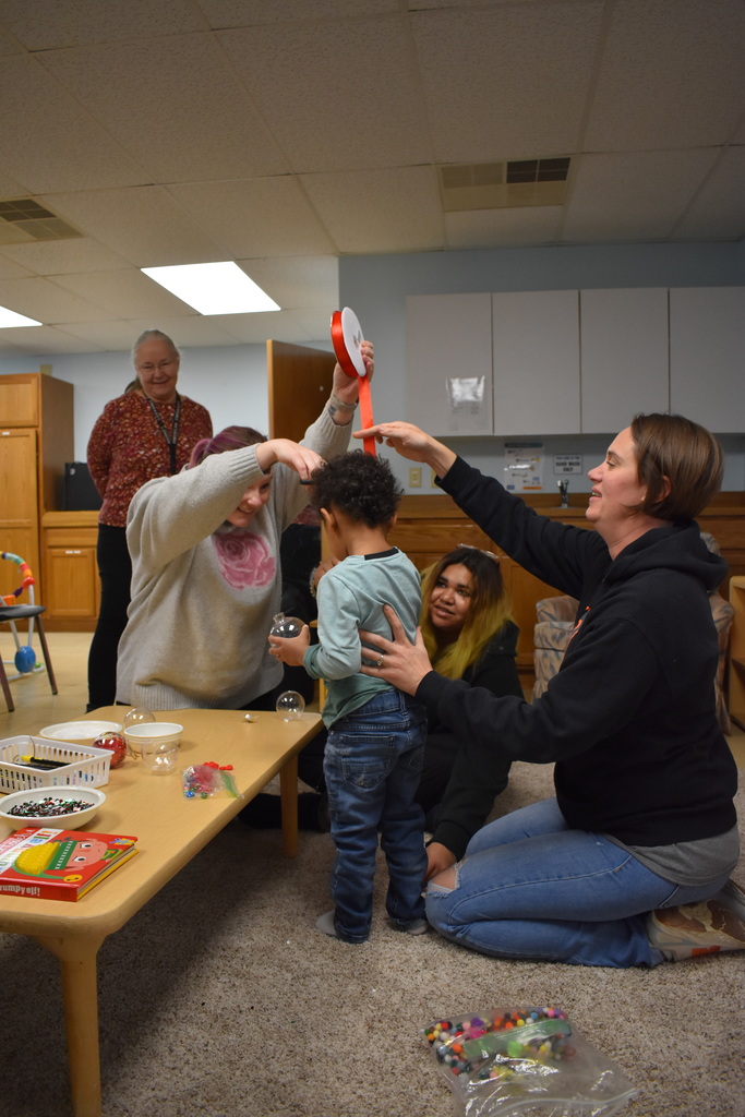 A group working on cutting the ribbon to a child's height