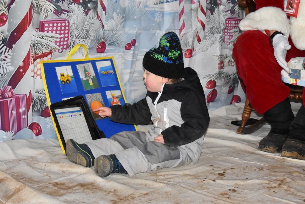 A young boy using his talker