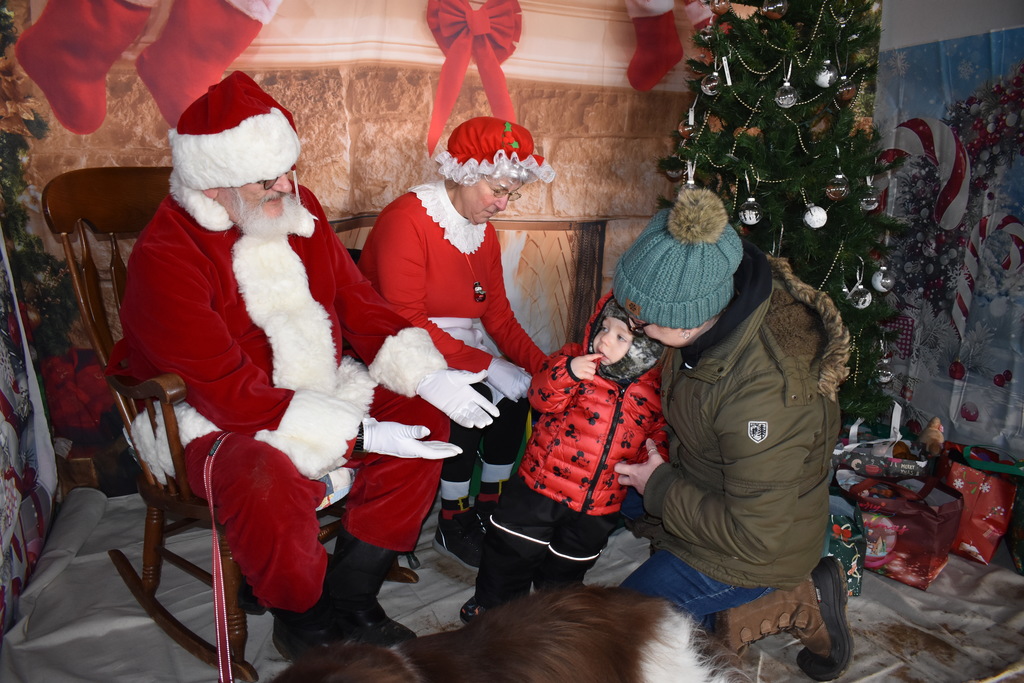 A little one determining whether he wants to go see Santa and Mrs. Claus