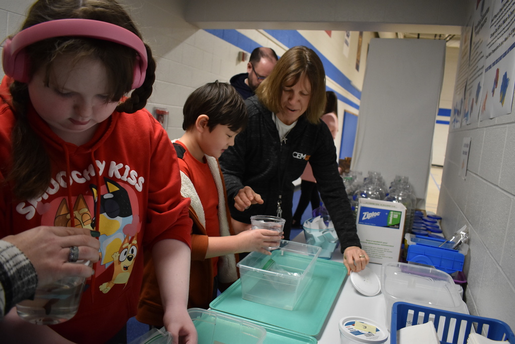Students moving their fish to their aquariums