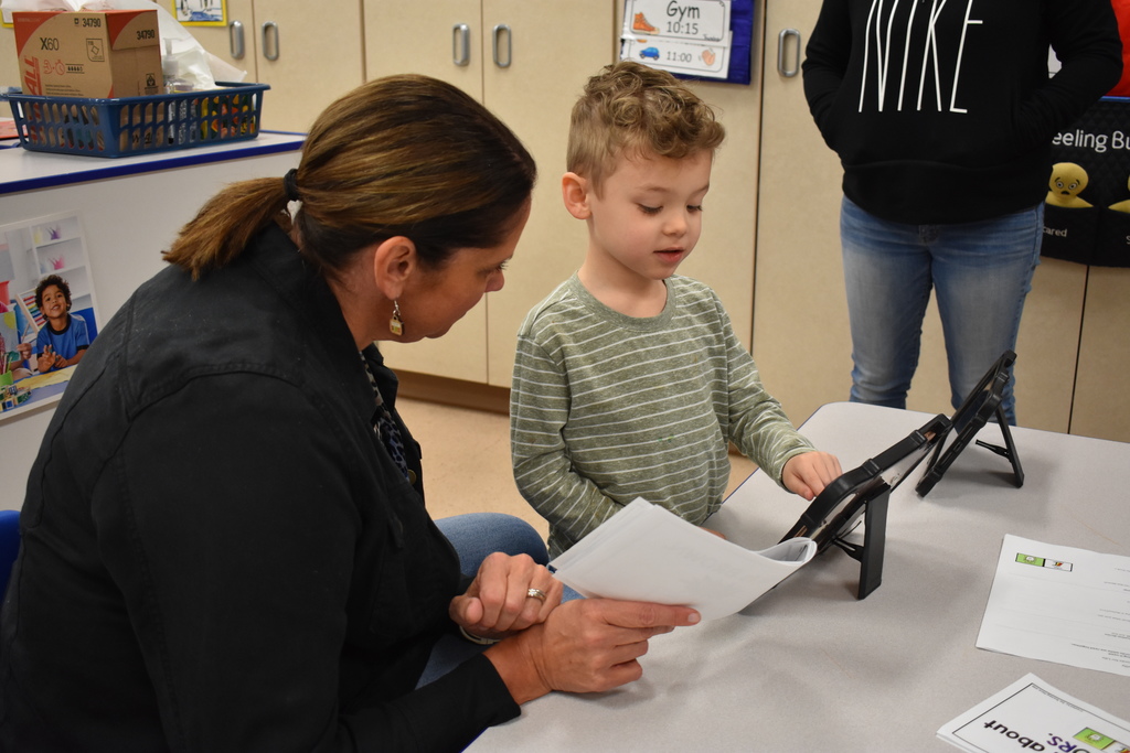 An instructor and student working on an ipad activity 