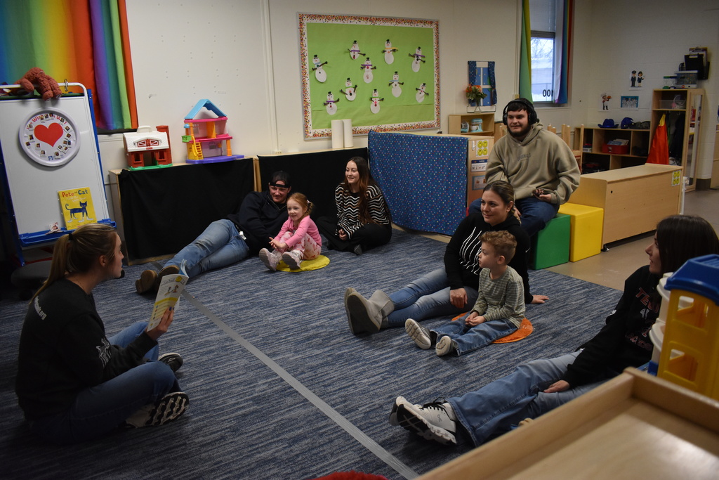Families listening to a story together
