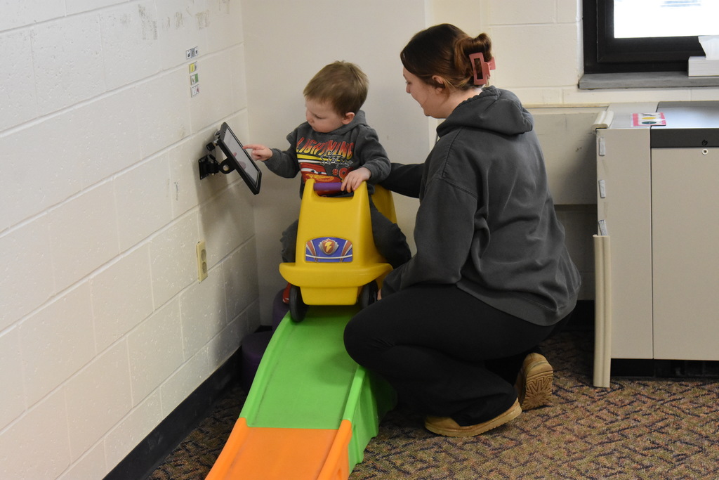A child and parent using an ipad to communicate