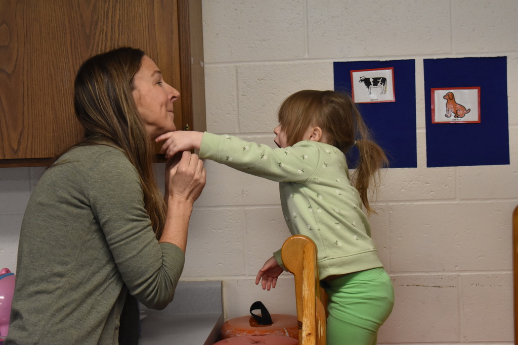 An instructor and student working on speech through images