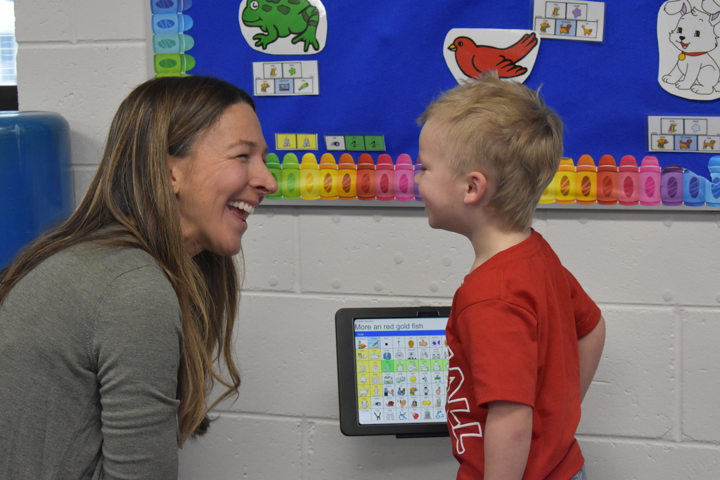 An instructor and student sharing a moment smiling at each other
