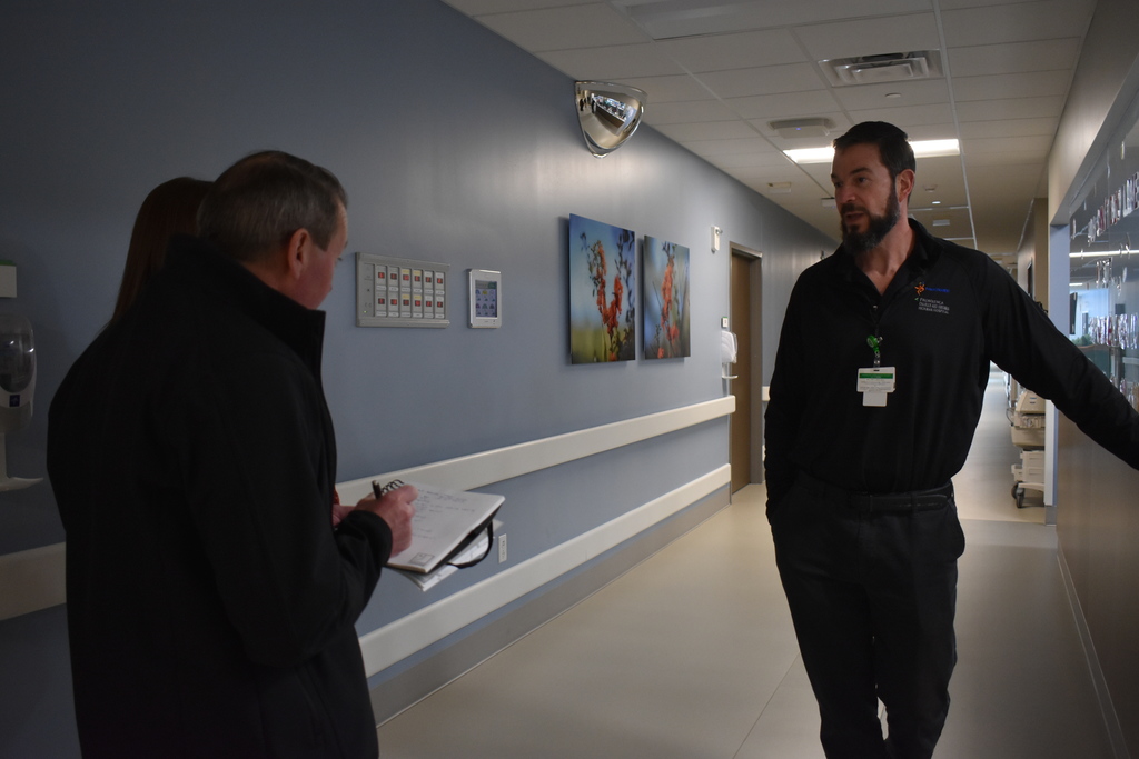 Glen leading a tour while Goodwill staff take notes