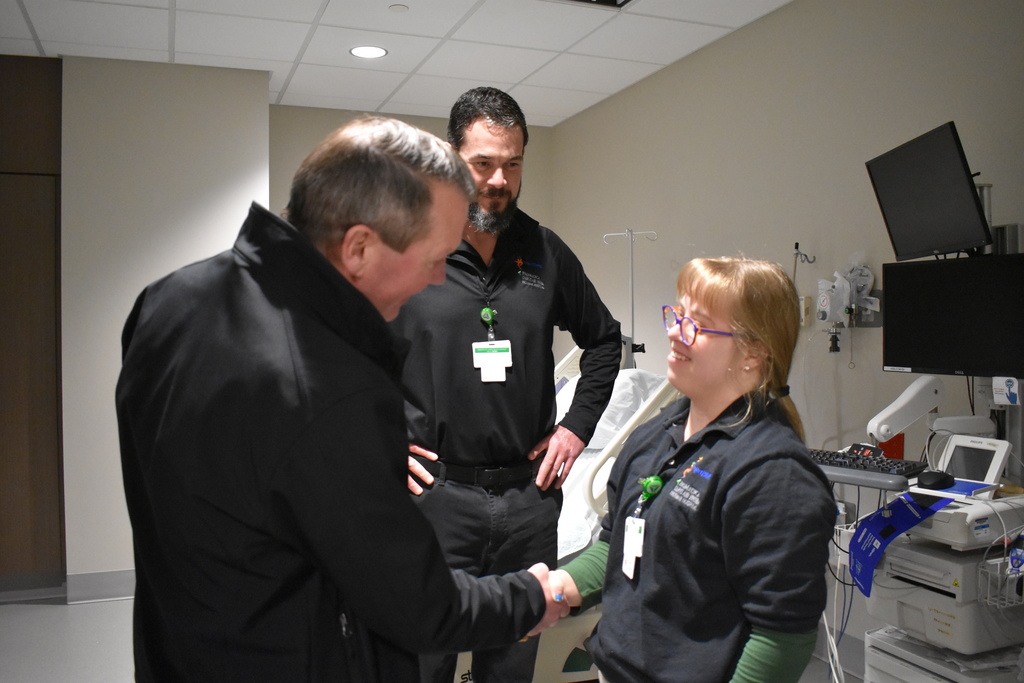 Goodwill CEO shaking a student's hand