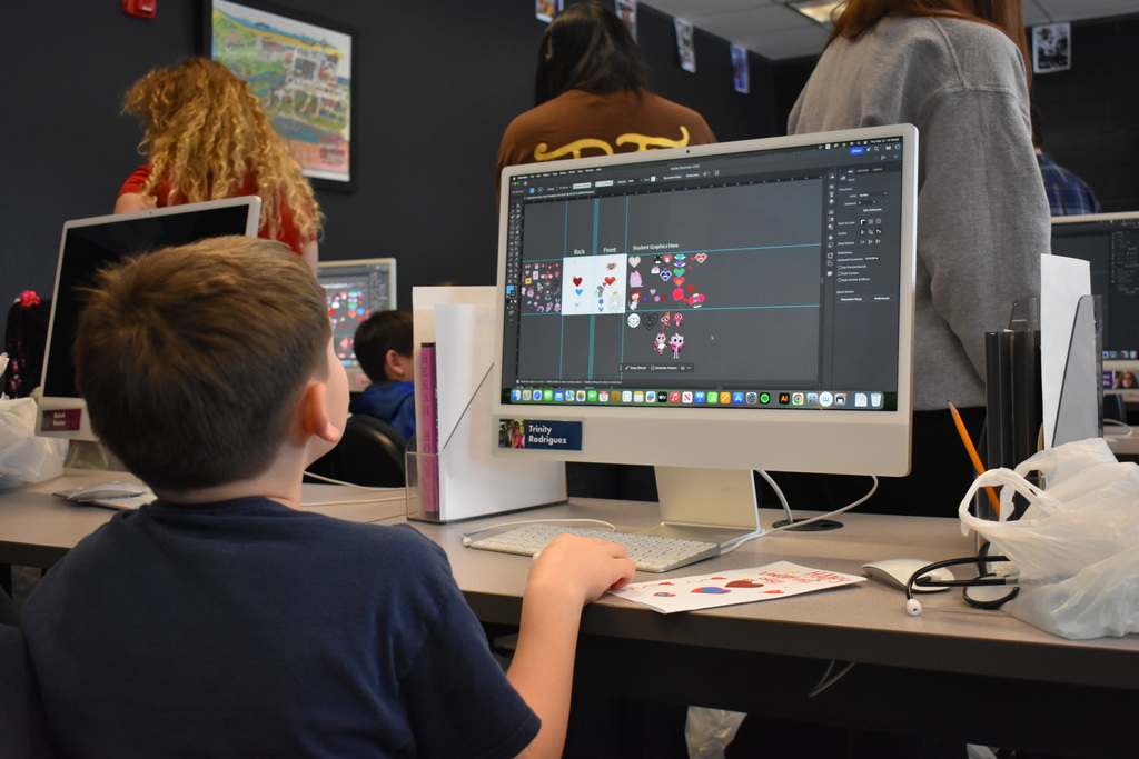 a student working on a graphic arts project on the computer