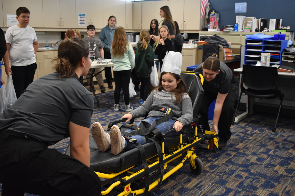 a student getting a ride in the EMT course