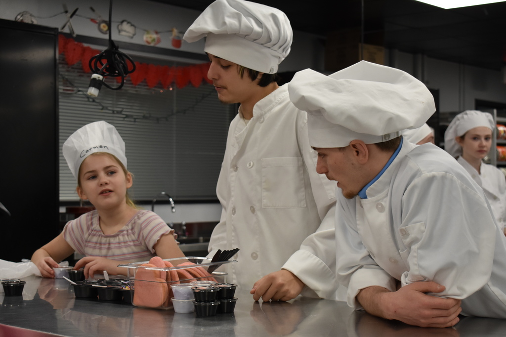 a student chats with two culinary students