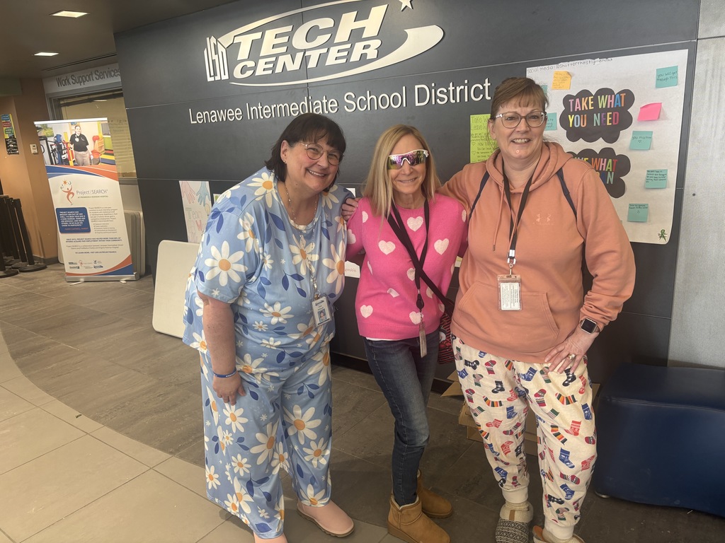 three staff dressed as students