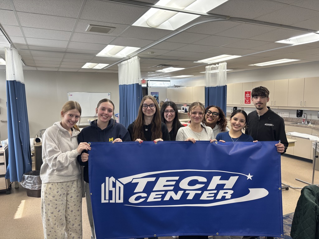 CNA students with banner