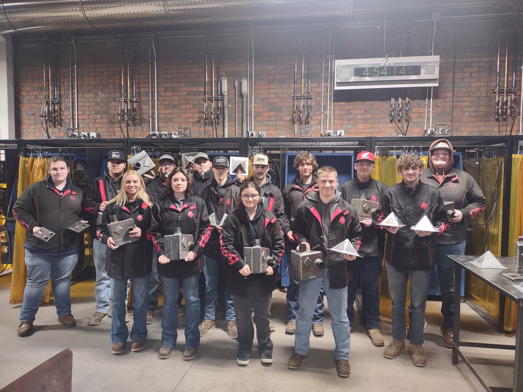 Welding students in a group posing with their awards