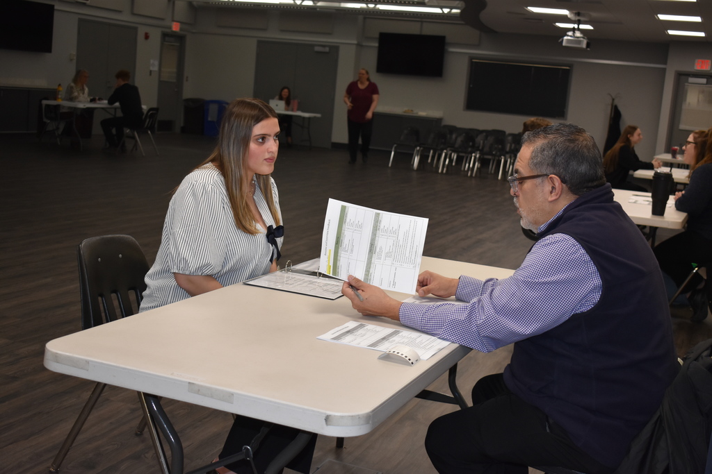 a student interviewing with a volunteer