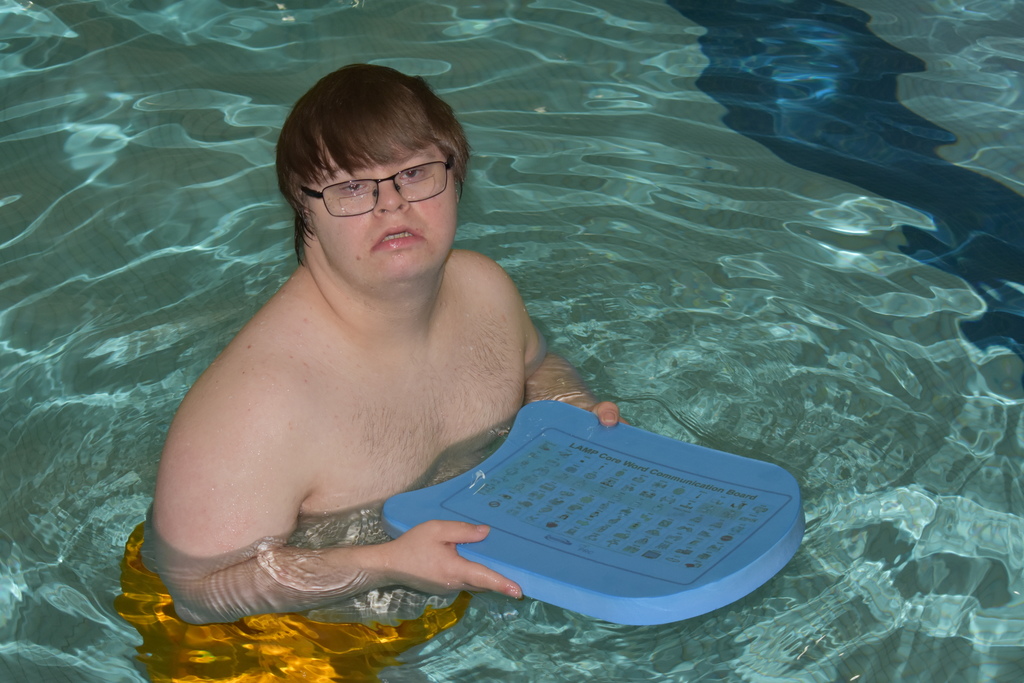 A student in the pool with a  communication float