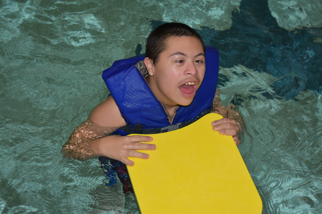 A student smiling in the pool