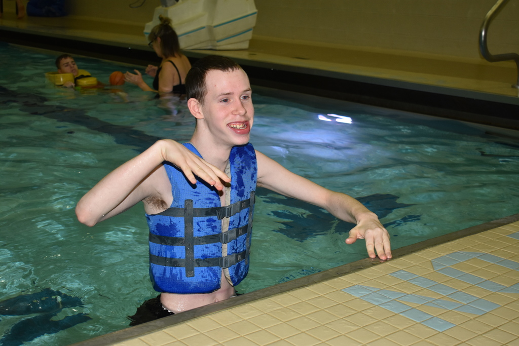 A student smiling in the pool