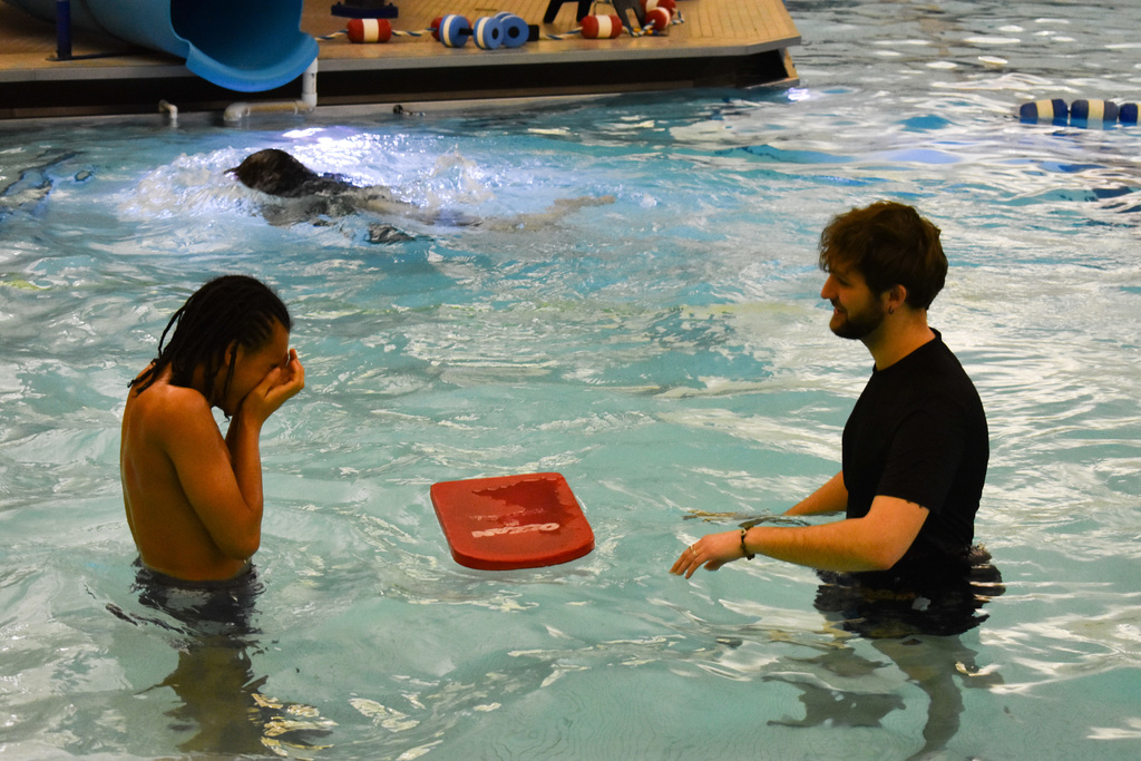 A student and instructor in the pool