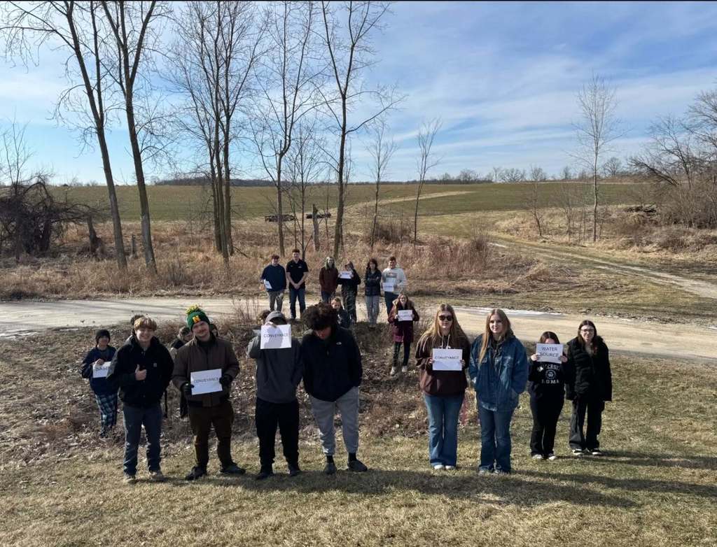 Students standing by the rain garden to label parts.