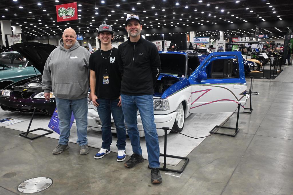 Carter pictured with his two TECH Center instructors and the vehicle he was showcasing