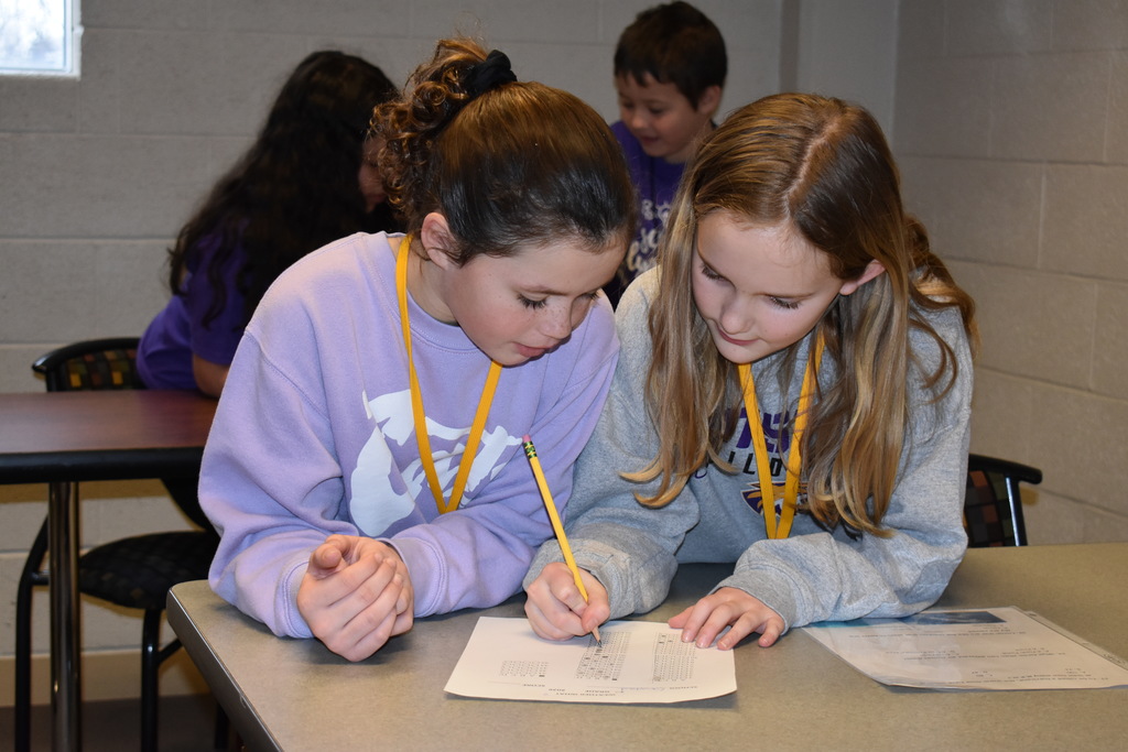 two students reading and answering a problem