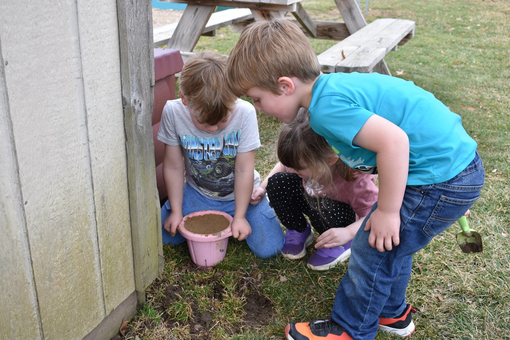 three kids searching for worms