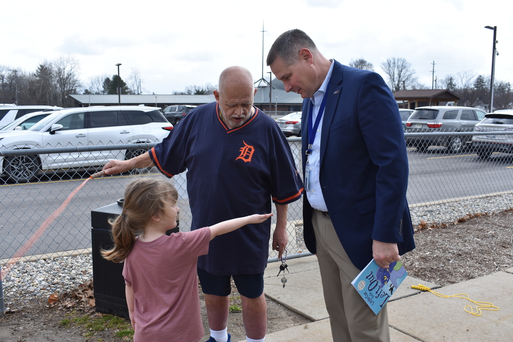 A child showing staff her worms she found