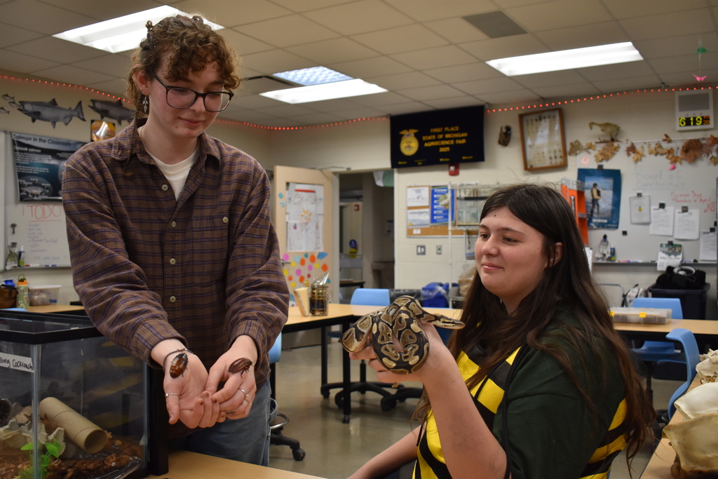 Two students with cockroaches and a snake