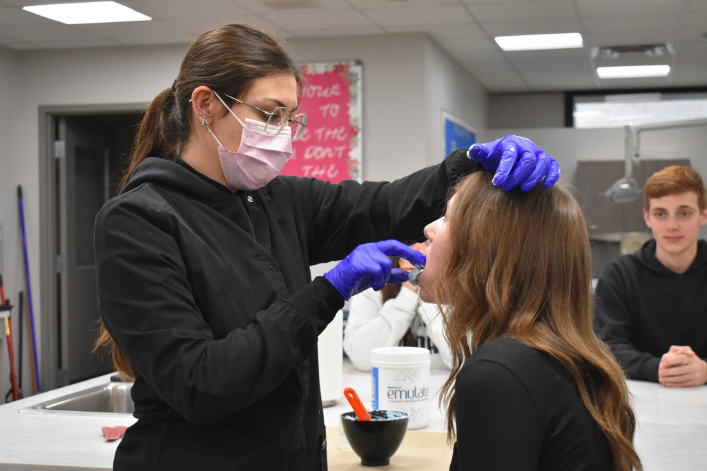 A dental student demonstrating on a relative