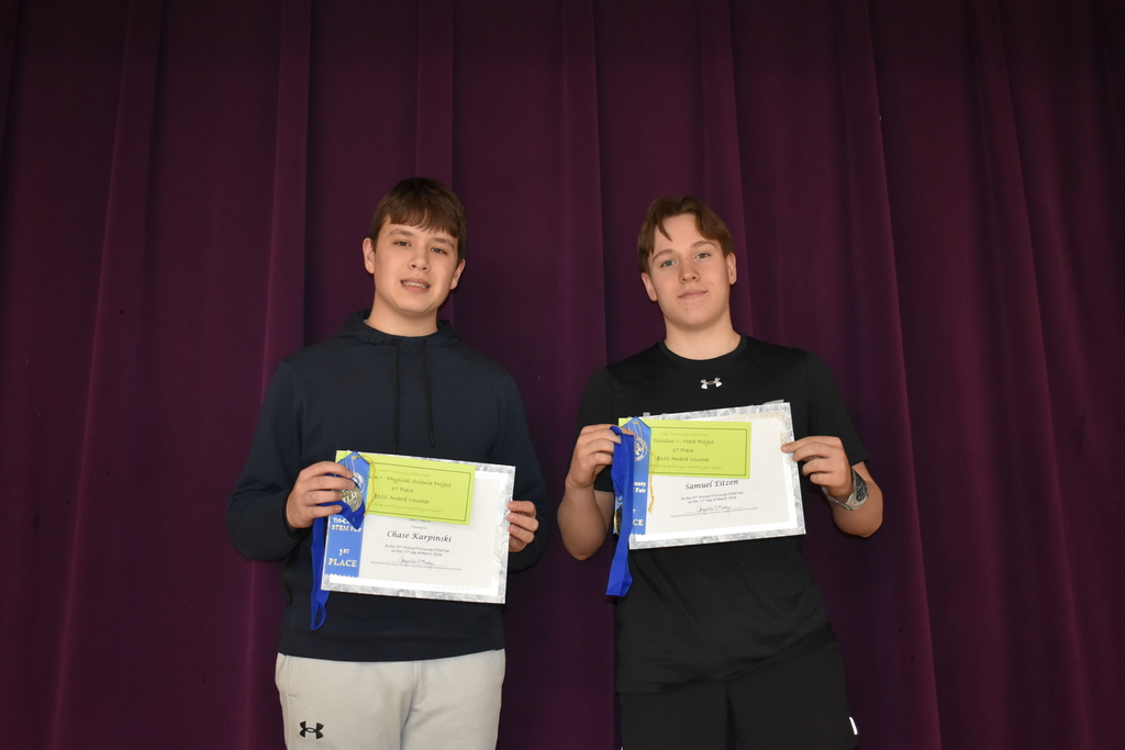 Two Blissfield students posing with their first place awards