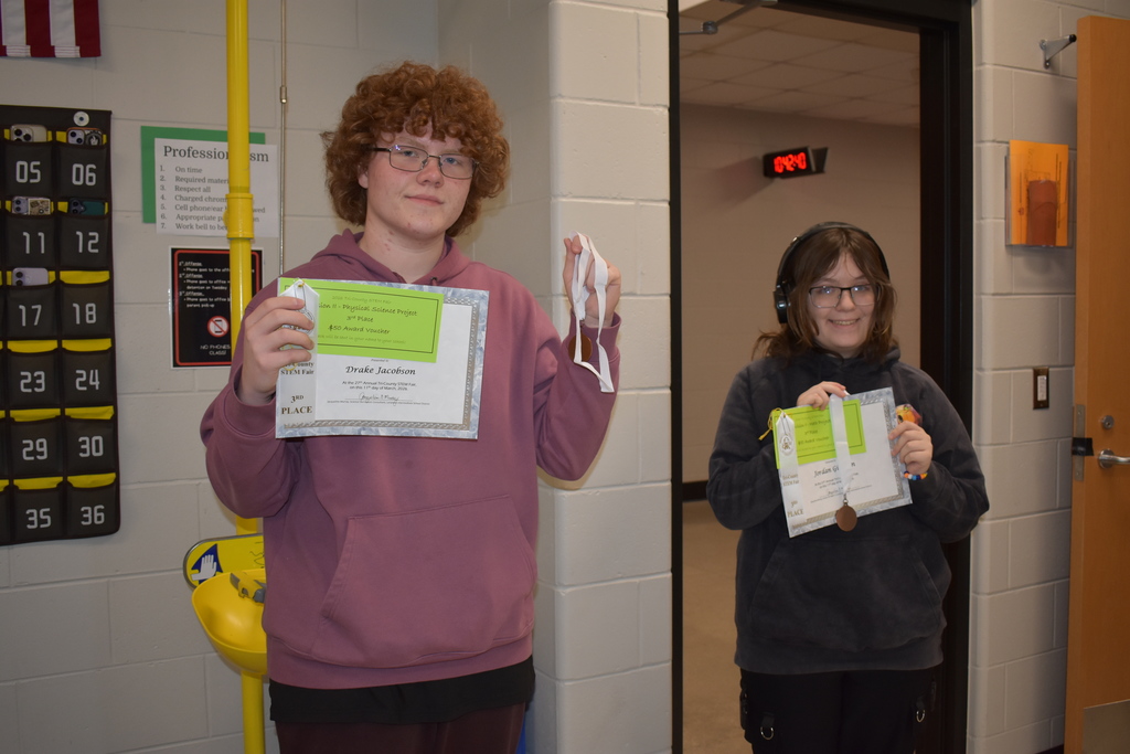 Two students posing with their awards