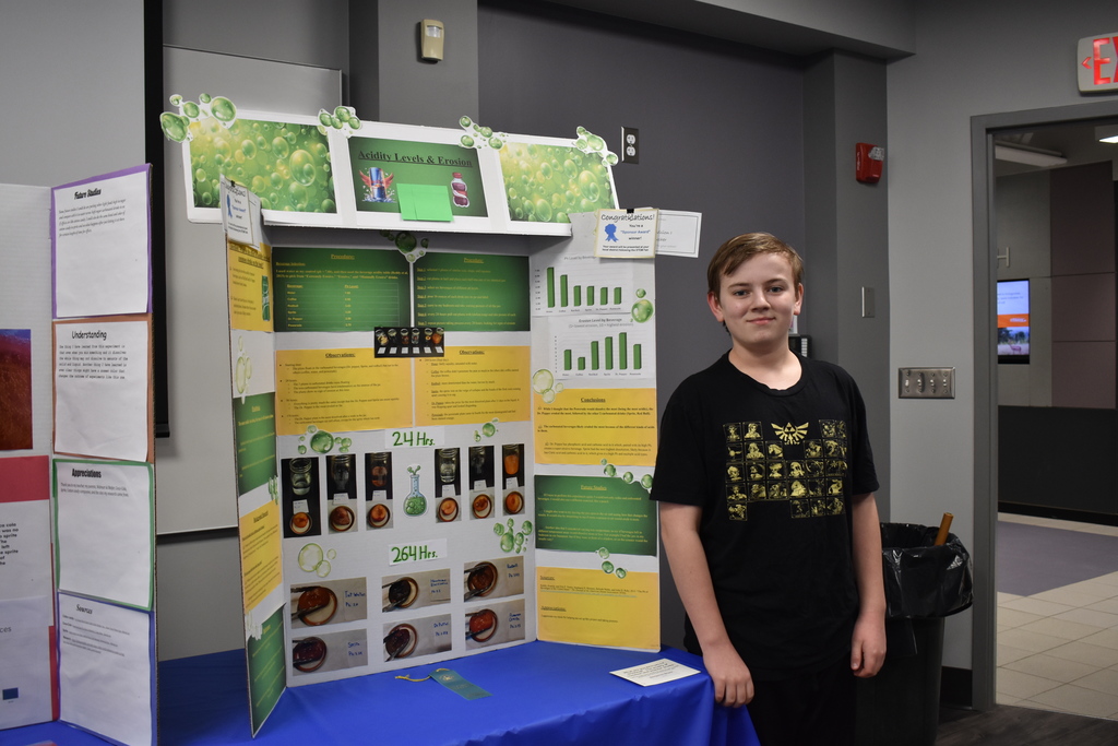 a student standing with his project