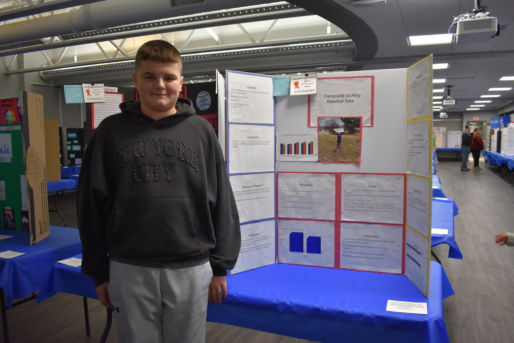 A student standing in front of his project