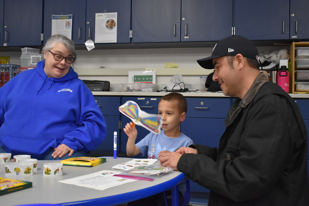 A child and a parent working on an art activity