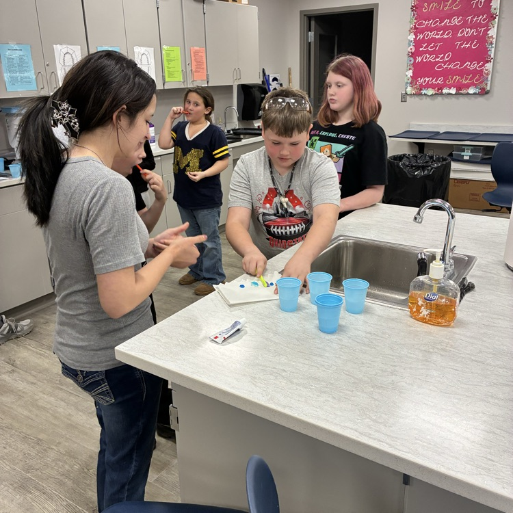 A student learning from TECH Center students in a lab