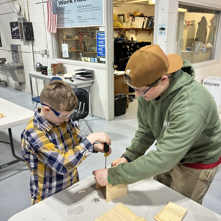 a student making a bird house with a TECH Center student 