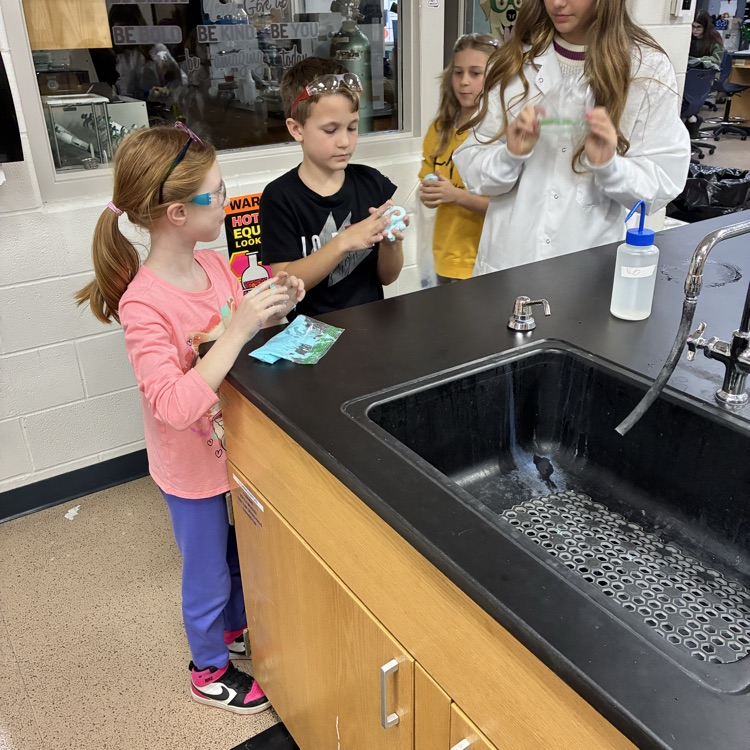 Students experiencing gooey stuff on their fingers in a lab