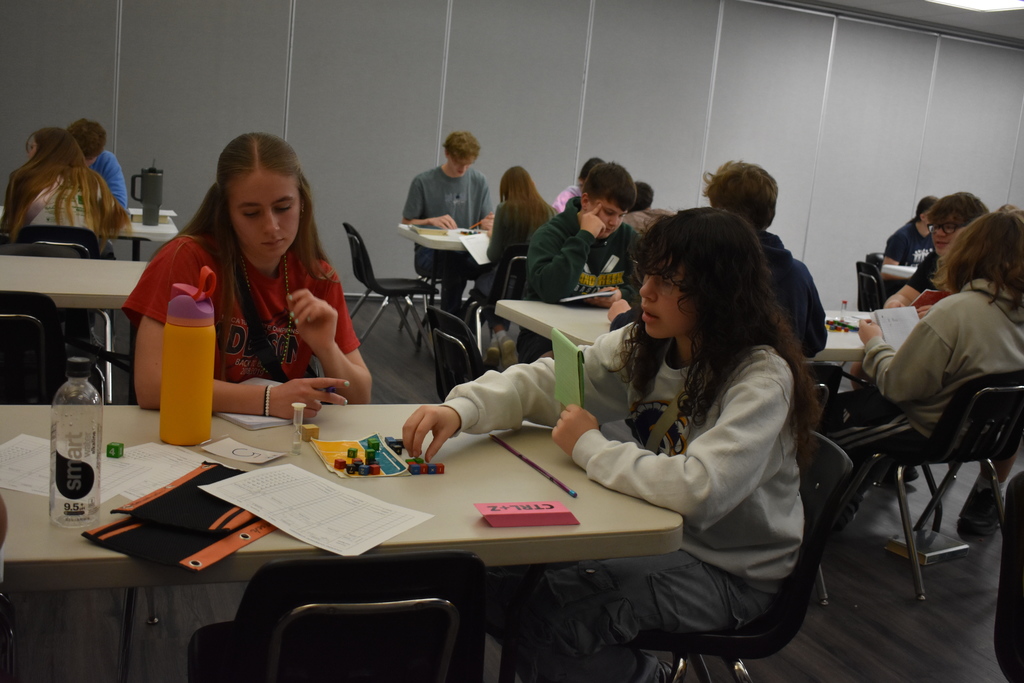 Two high school students playing against each other in equations