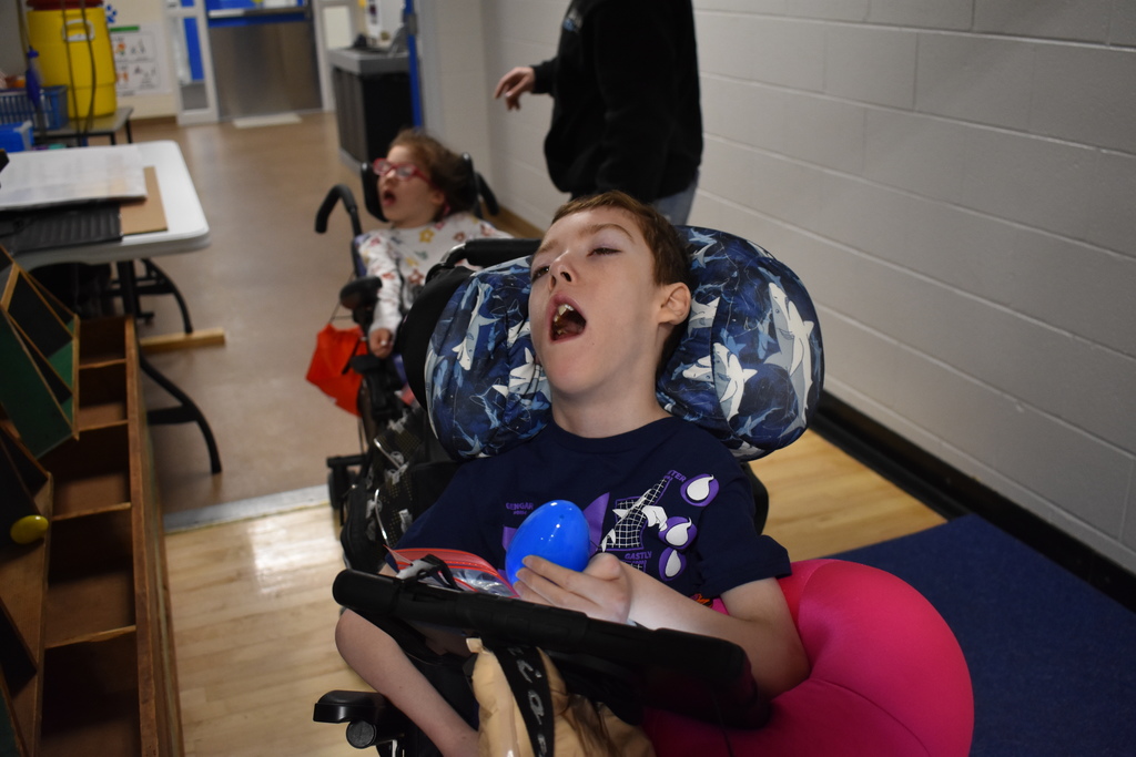 A young student with an egg in his hand