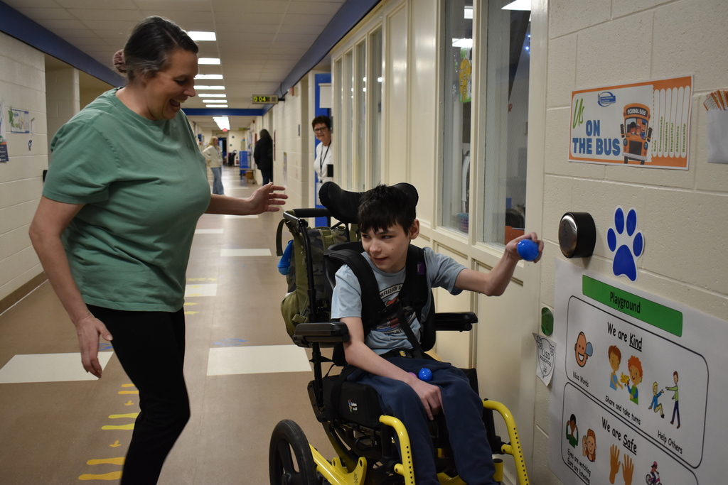 a student finding an egg as his teacher smiles next to him
