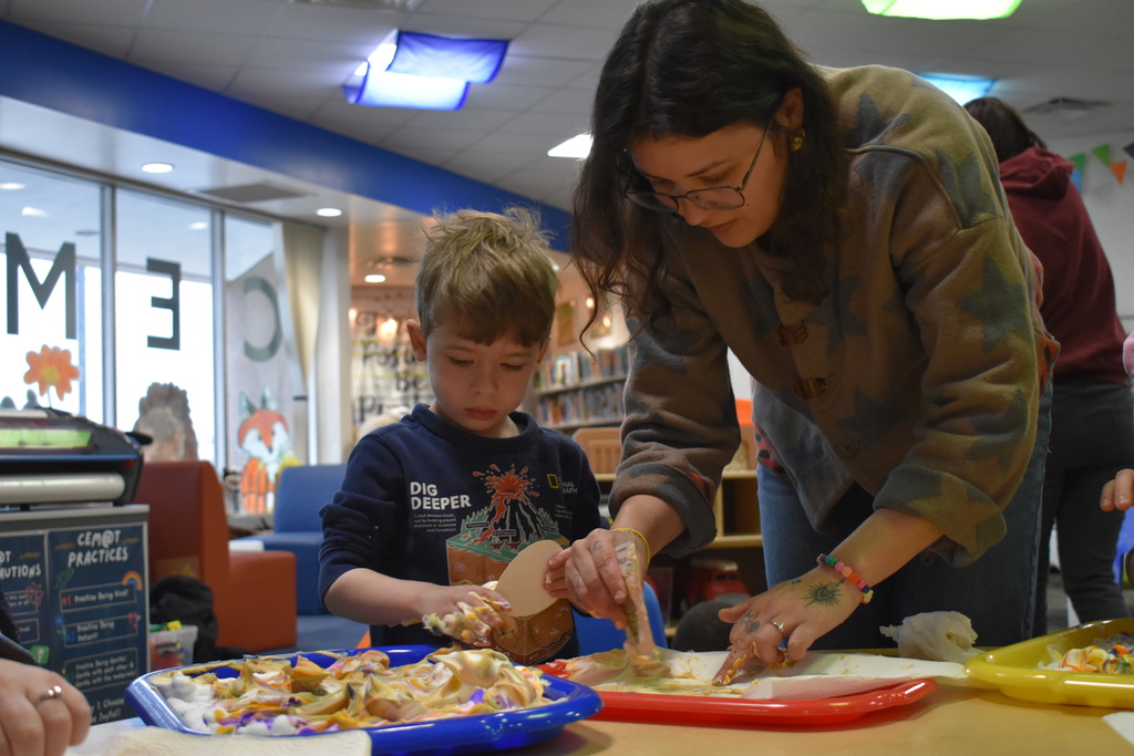 A parent and child dying eggs